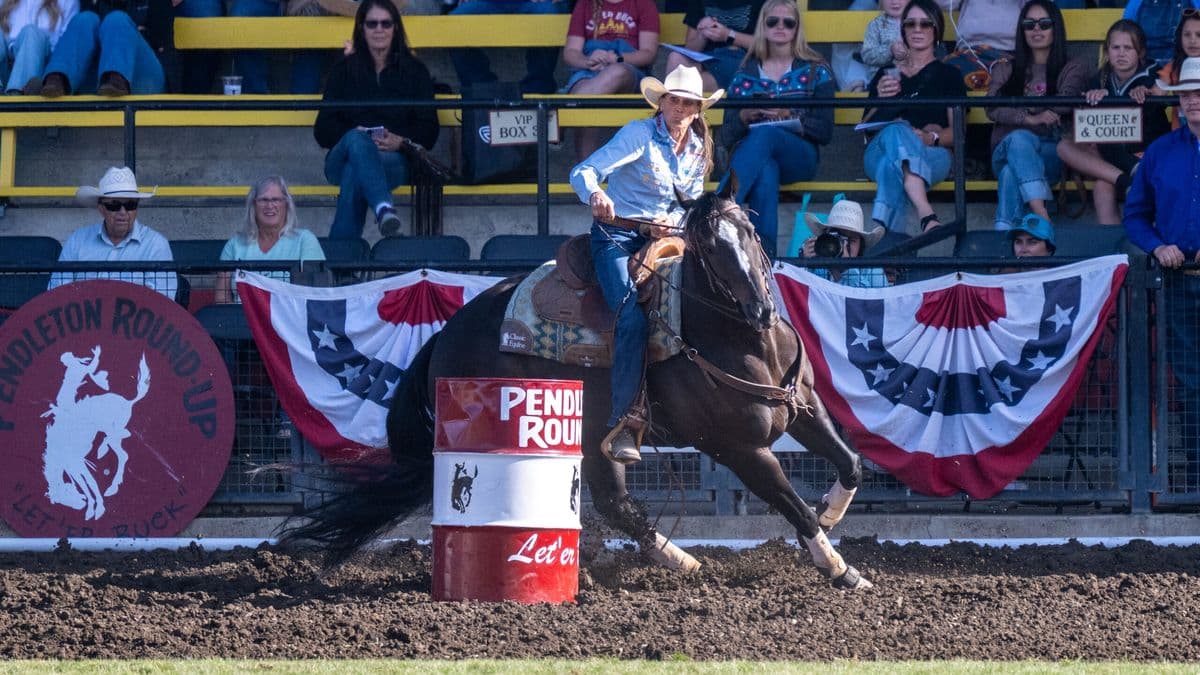 Lisa Lockhart turns a barrel at Pendleton Roundup on her black horse