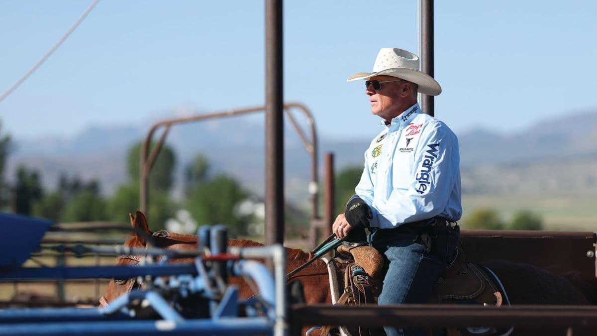 Clay O’Brien Cooper on horseback behind the roping chutes