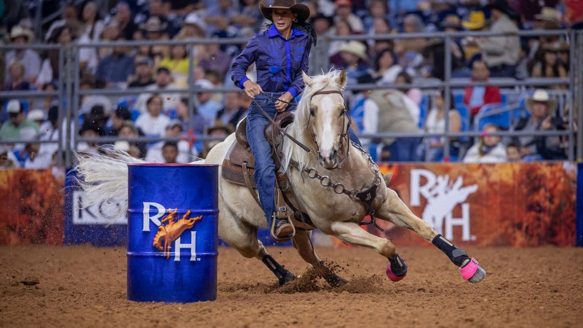 Latricia Duke and Carlos turn a blue RodeoHouston barrel