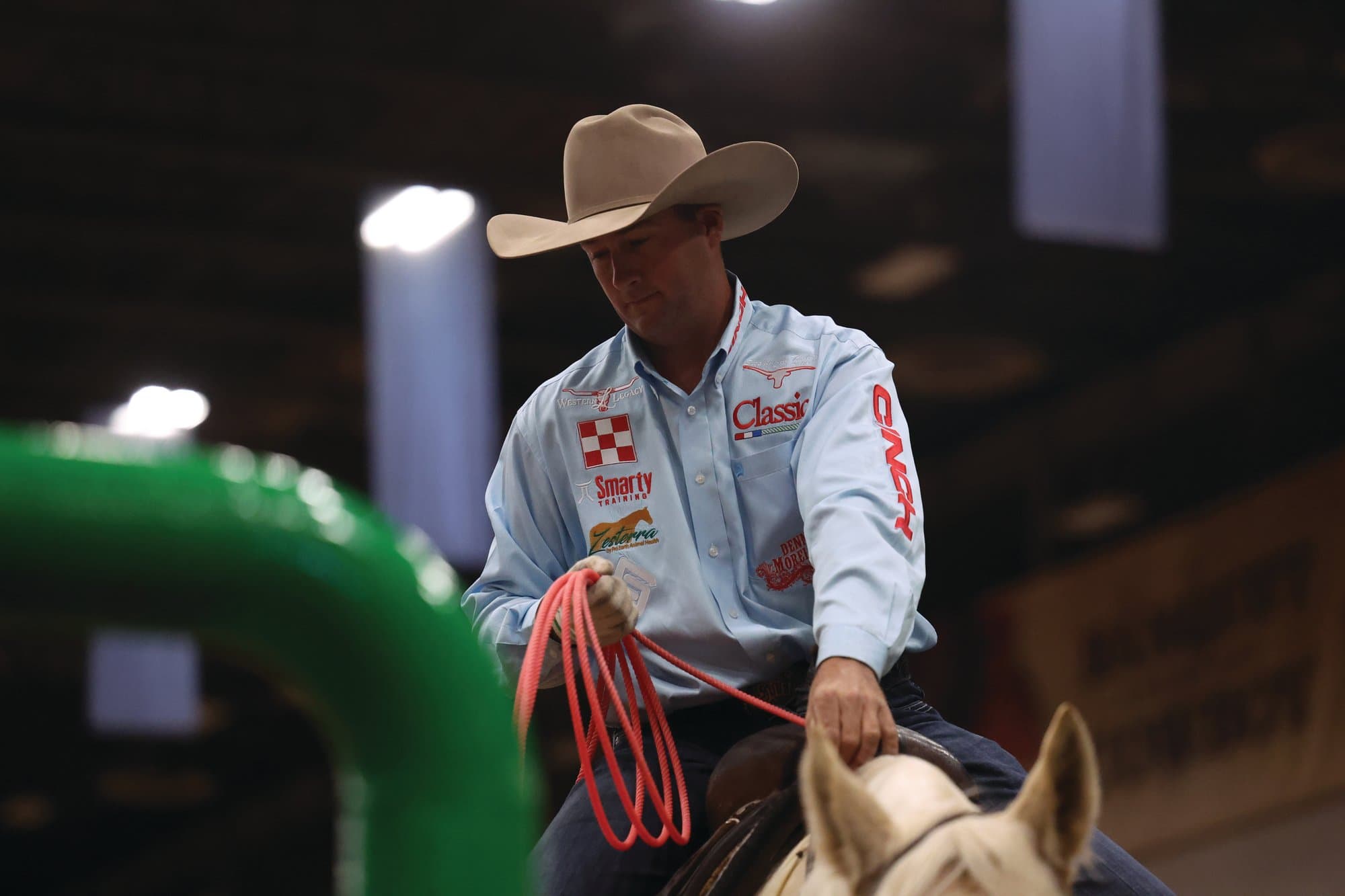 Tate Kirchenschlager on horseback holding his rope