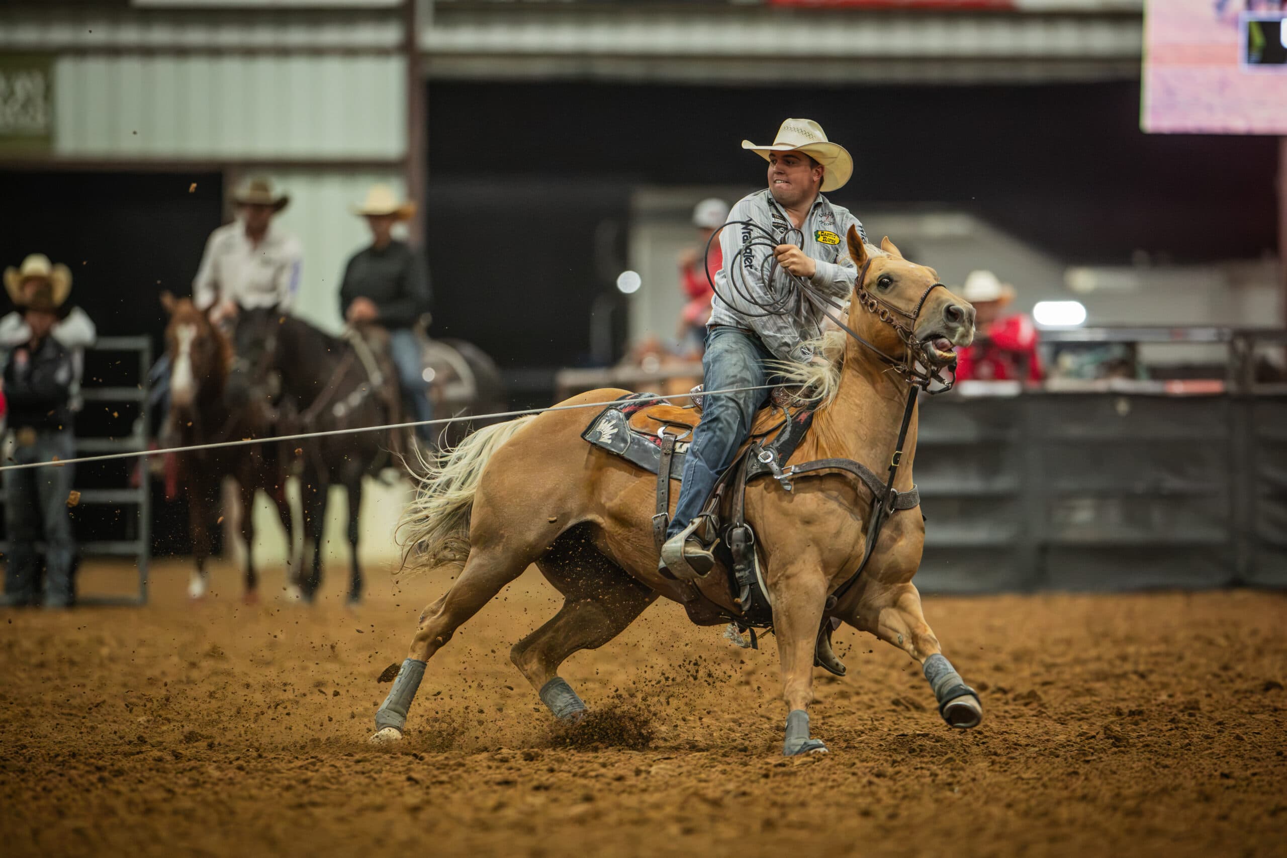 Ketch Kelton turns a steer on a palomino horse at the Last Hoorah in Stephenville, Texas.