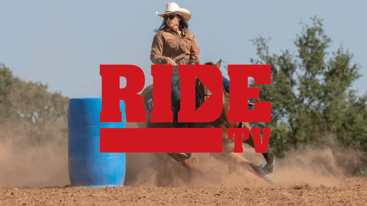 Barrel racer in a cowboy hat turning a blue barrel in a cloud of dust, with the red RIDE TV logo overlaid
