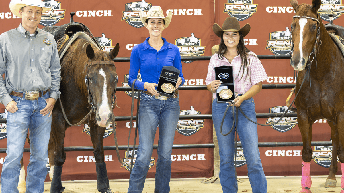 Four youth exhibitors stand with their horses against a Cinch branded backdrop, holding awards after competing in an equestrian event