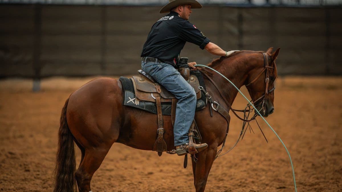 Hunter Koch pats Rockk Star, a sorrel gelding, on the neck in the arena at the Old West World Championships in Amarillo, Texas.