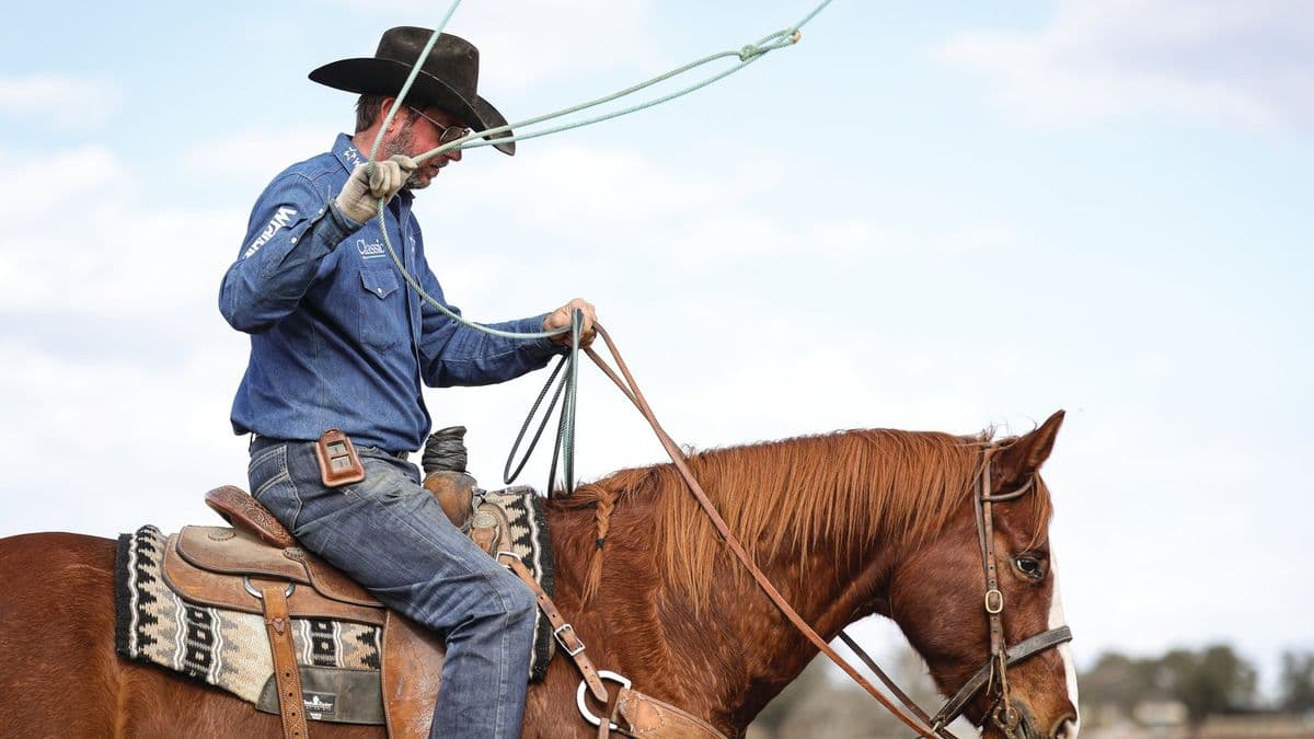 Logan Olson holding his rope and reins on a head horse