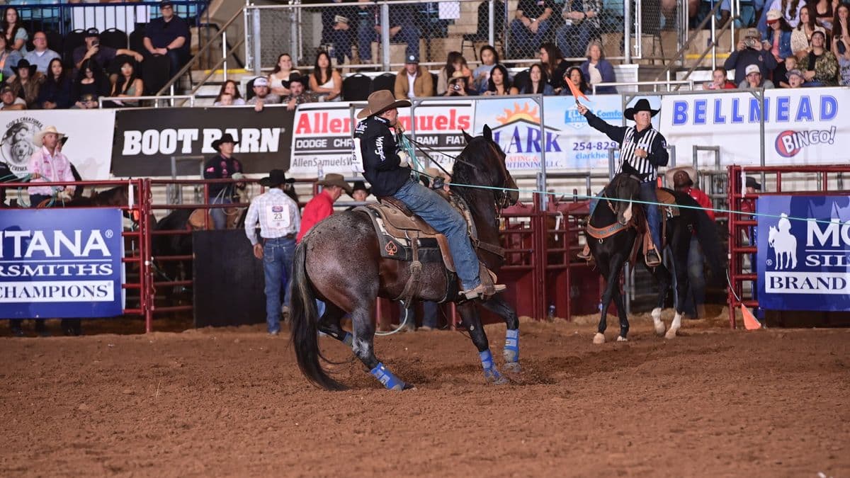 Ross Ashford rides a blue roan horse in the arena at the Texas Circuit Finals in Waco, Texas.