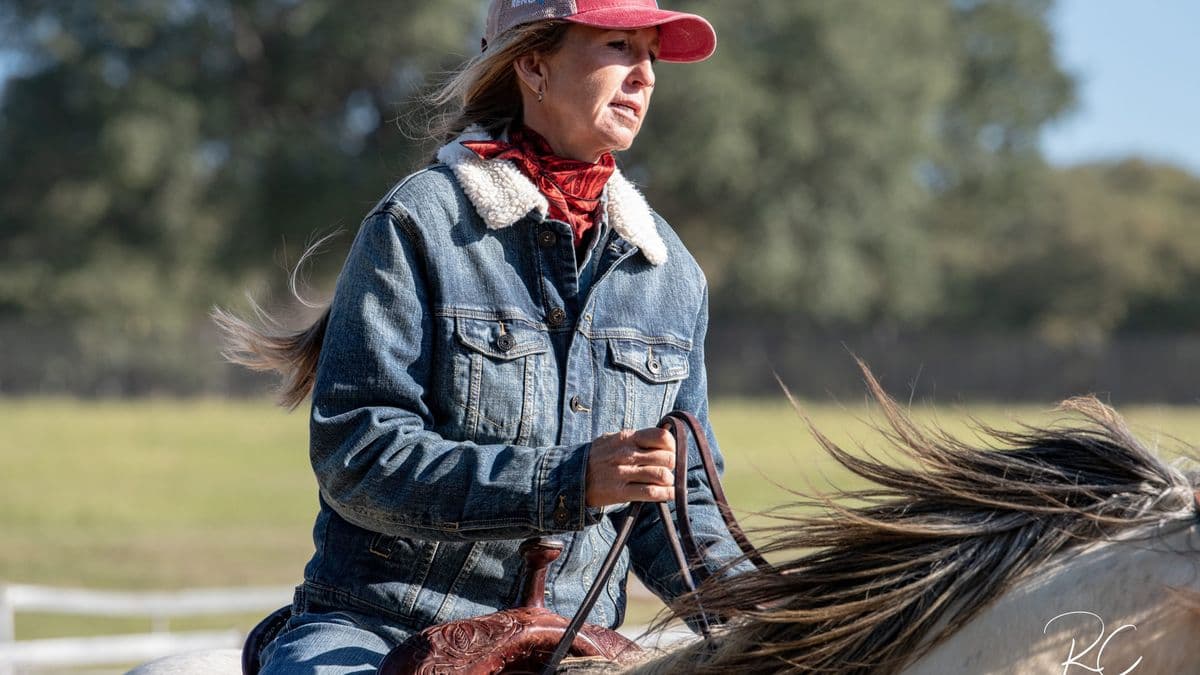 Cheyenne Wimberley loping a grey horse