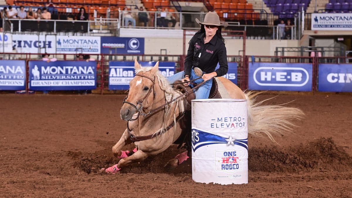 Morgan Addison turns a white barrel on a yellow horse