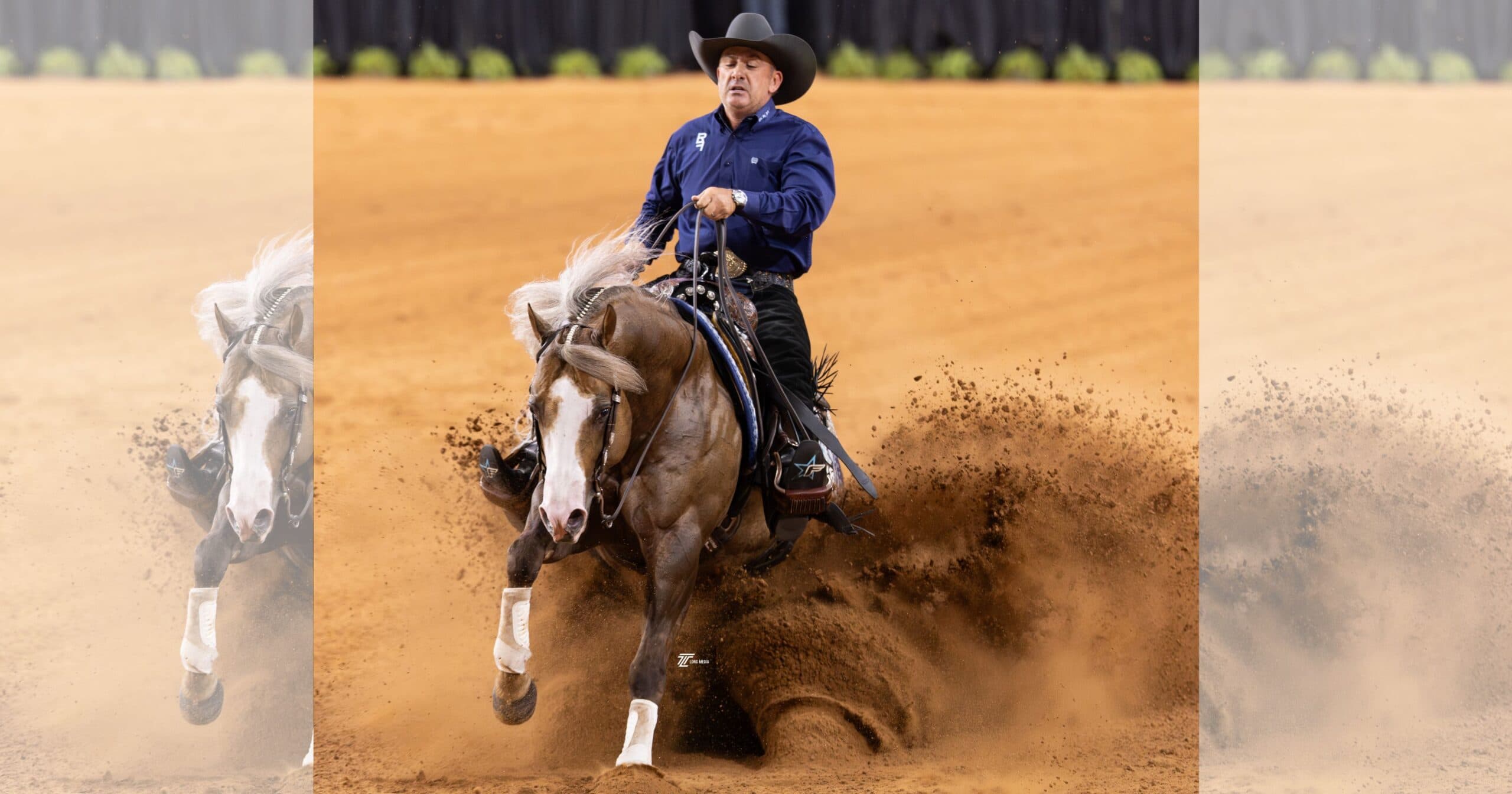 Cowboy in a black hat and navy shirt slides his palomino reining horse to a dramatic stop, spraying dirt across the arena