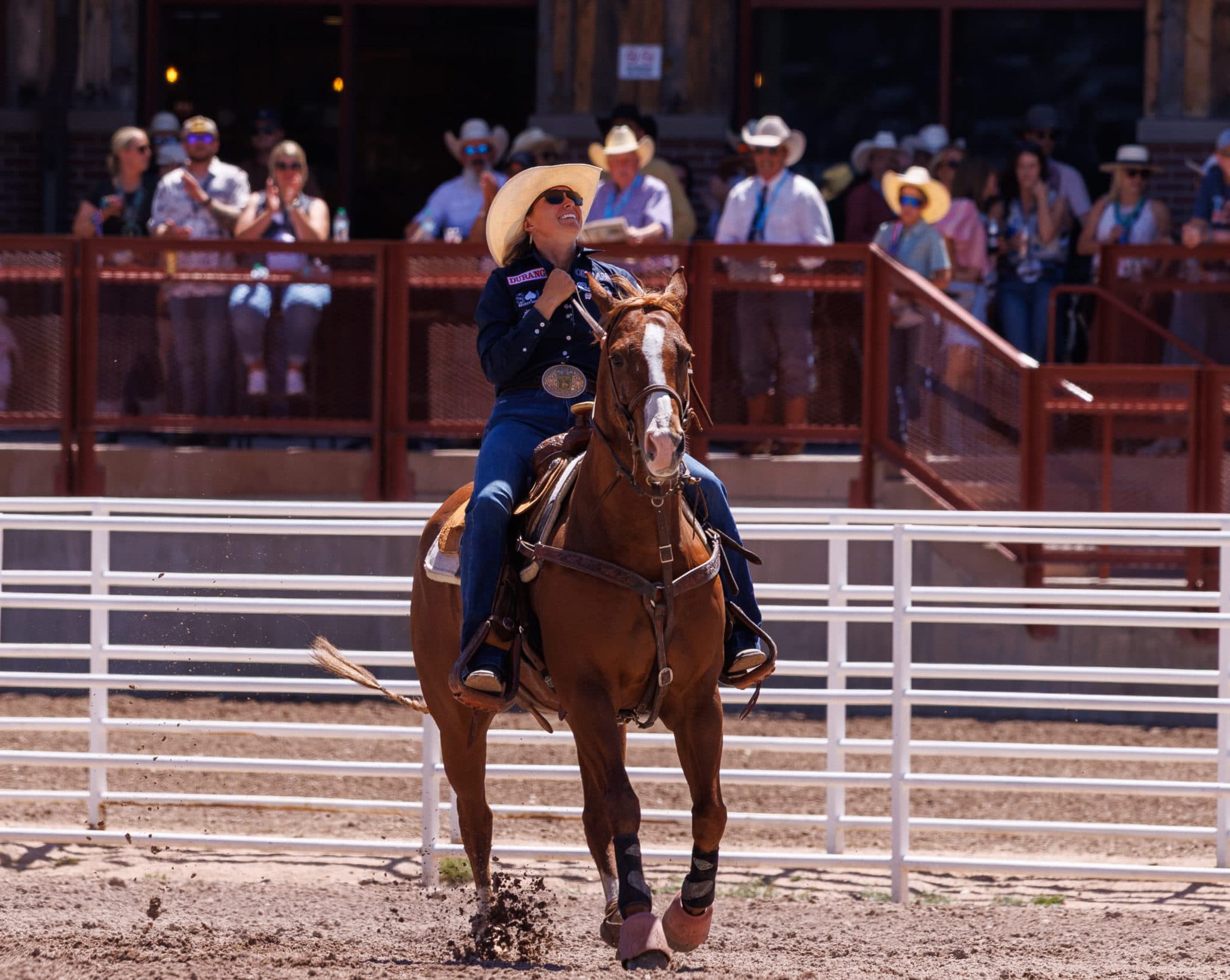 Cheyanne McCartney and horse Teddy riding out of the arena after goign 4.3 to win cheyenne frontier days
