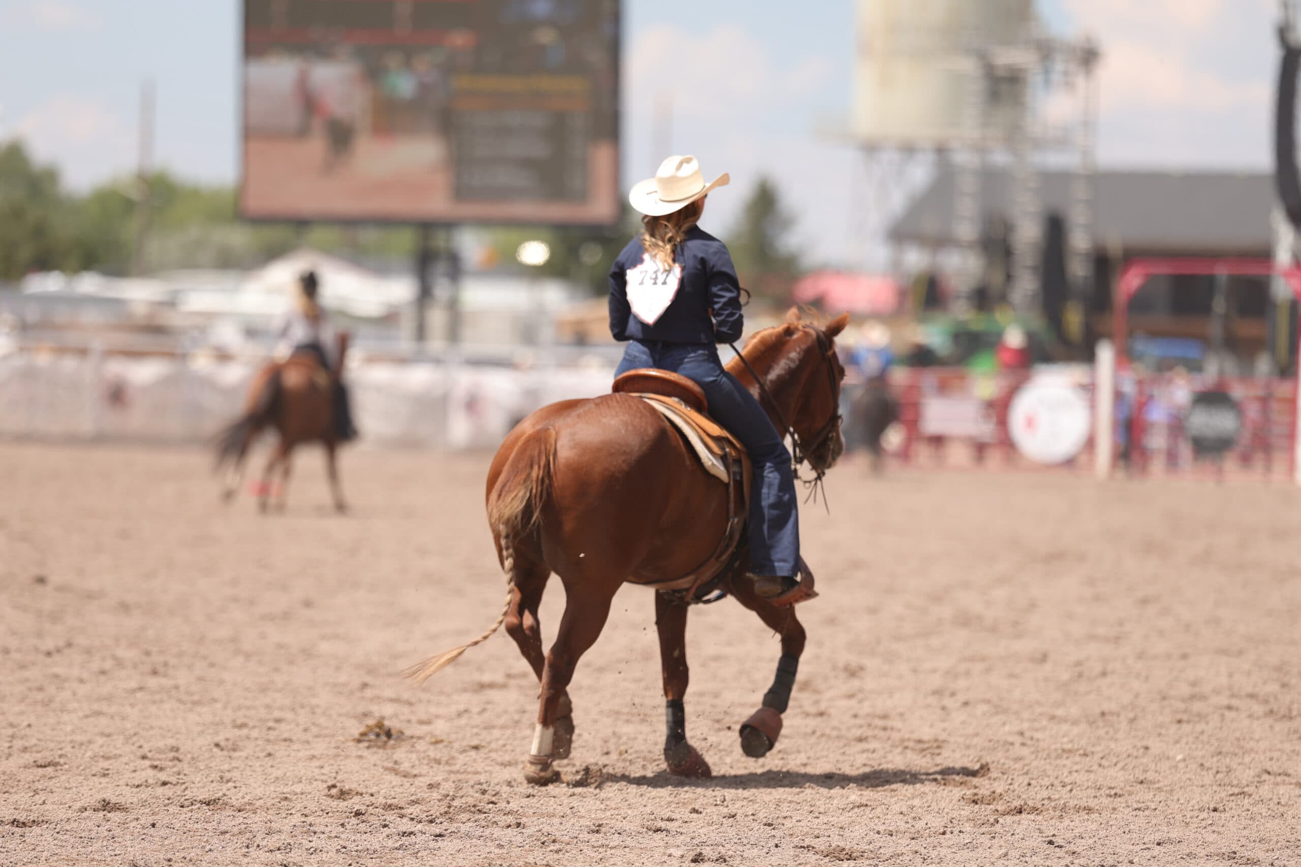 Cheyanne McCartney riding out of the arena after she wins her semifinals set with a 5.1