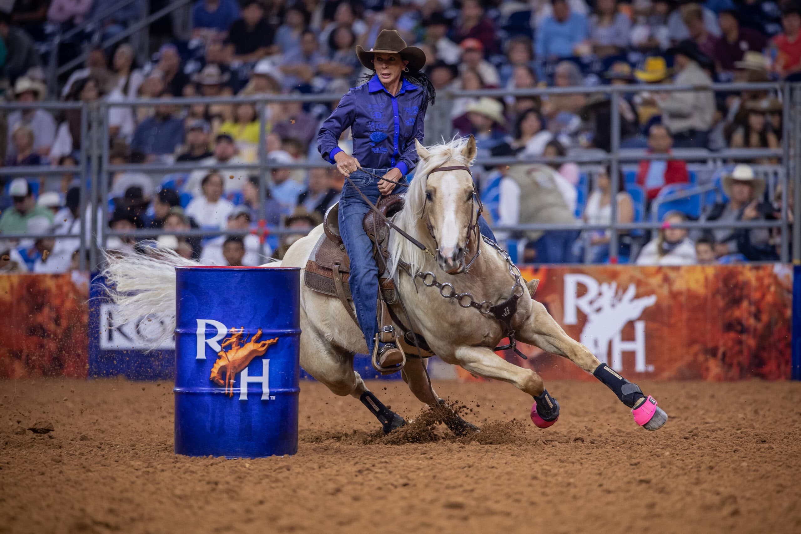 Latricia Duke and Carlos turn a blue RodeoHouston barrel