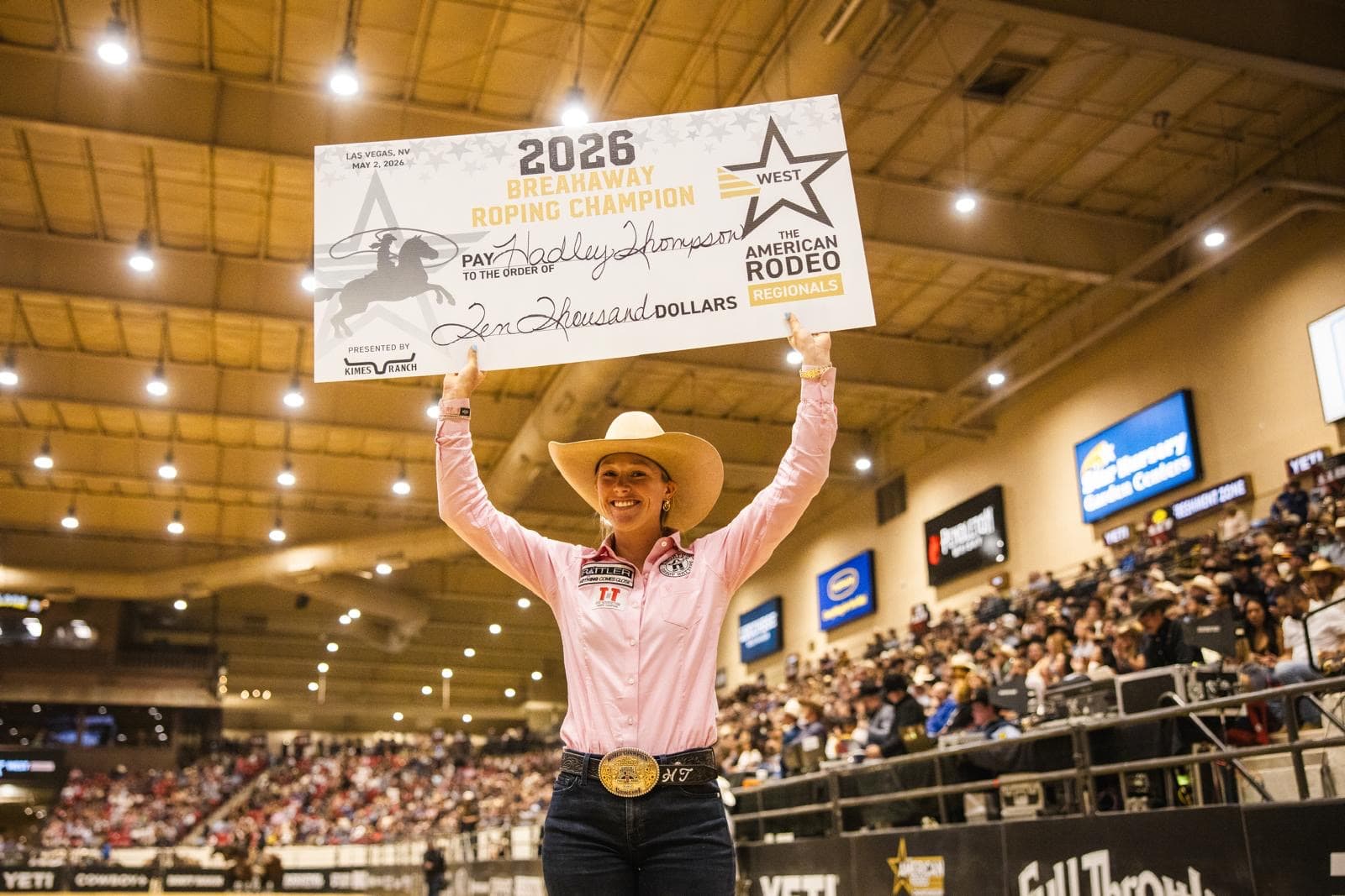 Hadley Thompson holds up her large check