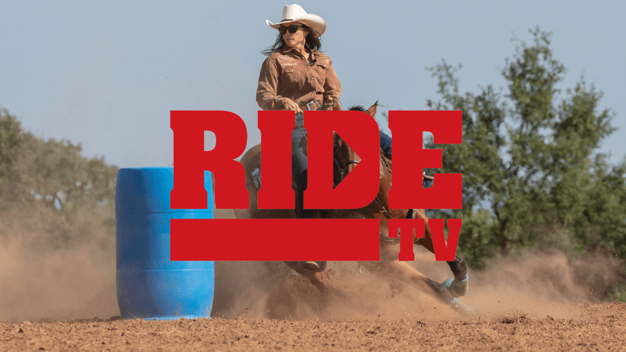 Barrel racer in a cowboy hat turning a blue barrel in a cloud of dust, with the red RIDE TV logo overlaid