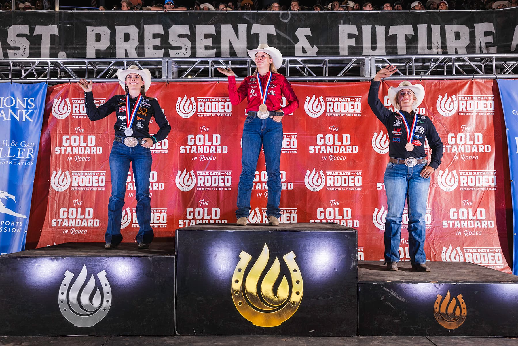 Left to right, Shelby Meged, Beau Peterson and Maddy Jacobs on the podium for the Days of 47 Rodeo in Salt Lake City.