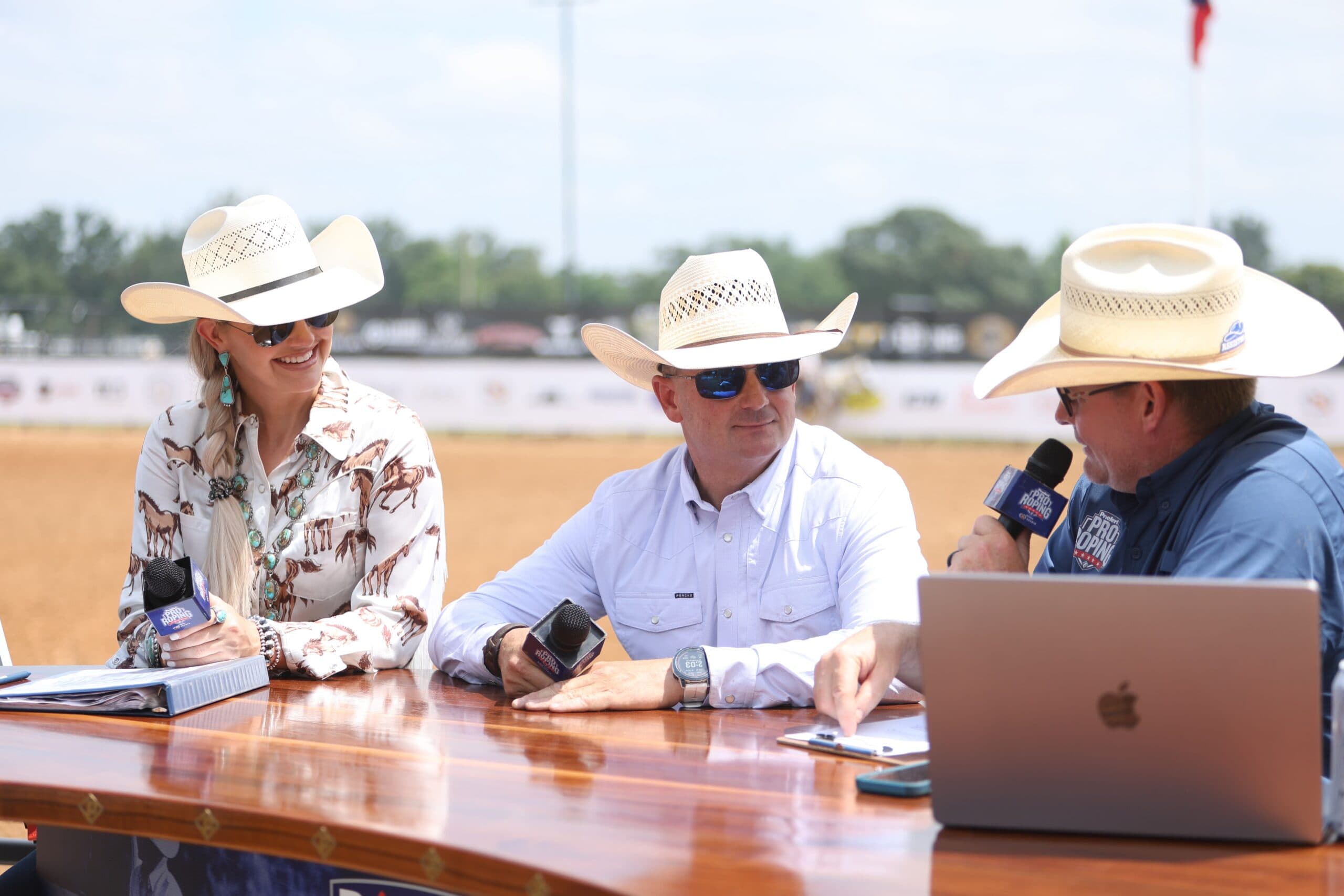 Amy Wilson sits at the Priefert Sports Desk at her first event working for Equine Network alongside Redgie Probst of Quanta Services and fellow commentator Dru Stewart.