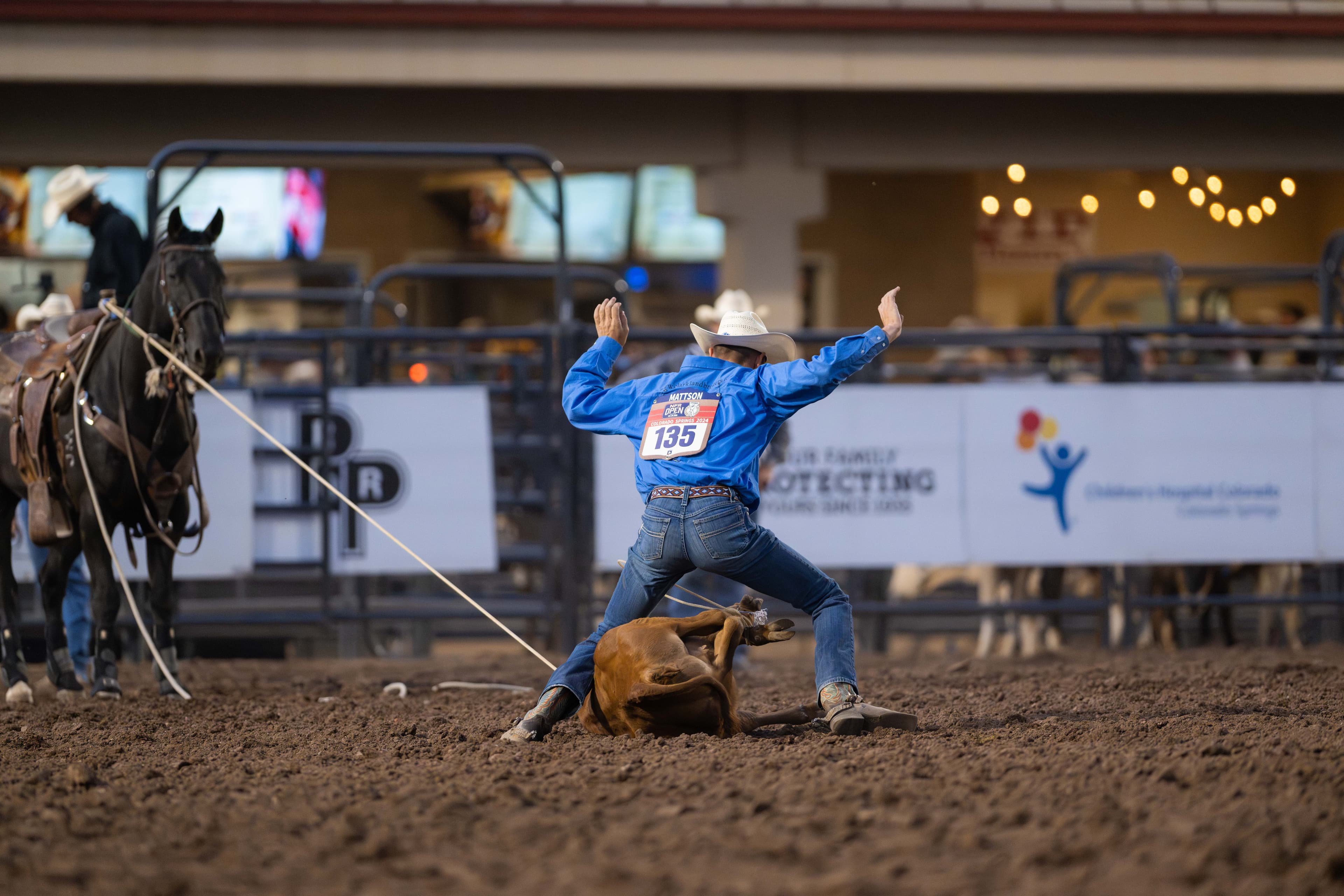 Bodie Mattson throwing his hands in the air after trying his final calf at the 2024 NFR Open.